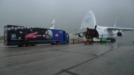 Outside broadcast truck being loaded into fuselage of Antonov
  transporter plane